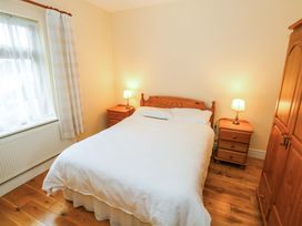 A bedroom with a bed and nightstands at Geesala in Gweesalia