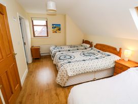 A bedroom with two beds and a nightstand at Geesala in Gweesalia