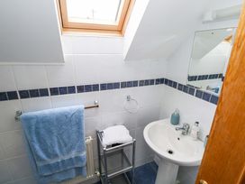 A bathroom with a sink and towel rack at Geesala in Gweesalia