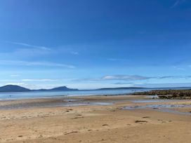 A beach with sand and sea under a clear sky at Geesala in Gweesalia