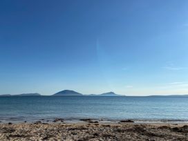 A beach view with mountains in the distance at Geesala in Gweesalia