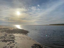 A view of water and sand with a fishing pole at Geesala in Gweesalia