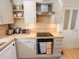 A kitchen with toaster kettle and bread box on countertop at 4 Martindales Yard in Kendal