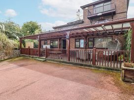 A deck with seating and plants at Acorns Holywell