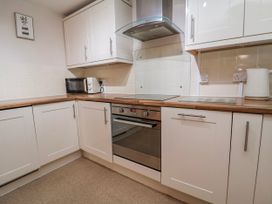 A kitchen with microwave and oven at Acorns in Holywell