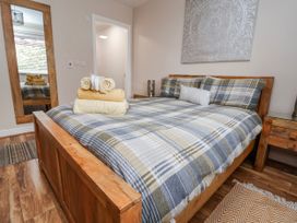A bedroom with a bed and towels on top at Acorns in Holywell