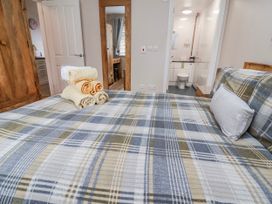 A bedroom with a bed and towels arranged at Acorns in Holywell