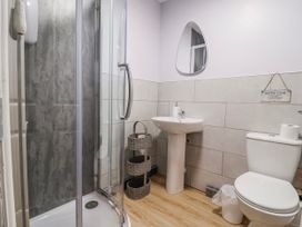 A bathroom with a shower, sink, and toilet at Acorns in Holywell