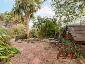 A garden area with a tree and seating at Acorns Holywell