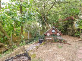 A garden with plants and a small table and chairs at Acorns in Holywell