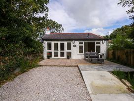 An outdoor area with a patio and table at Cromlech Cottage at Cromlech Manor Farm Tyn-y-Gongl near Benllech