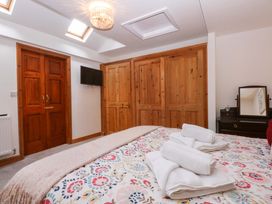 A bedroom with a bed and towels on it at Cromlech Cottage at Cromlech Manor Farm in Tyn-y-Gongl near Benllech