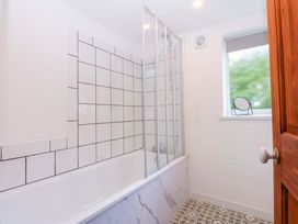 A bathroom featuring a bathtub and shower enclosure at Cromlech Cottage at Cromlech Manor Farm, Tyn-y-Gongl near Benllech