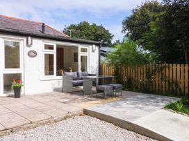 An outdoor area with patio furniture at Cromlech Cottage at Cromlech Manor Farm, Tyn-y-Gongl near Benllech