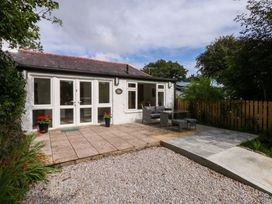 An outdoor area with patio furniture at Cromlech Cottage at Cromlech Manor Farm near Tyn-y-Gongl