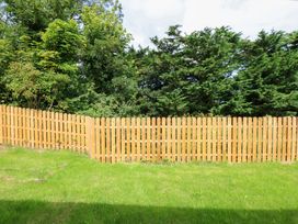 A wooden fence in an outdoor area at Cromlech Cottage at Cromlech Manor Farm Tyn-y-Gongl near Benllech