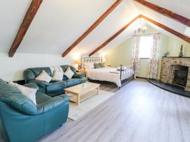 A bedroom with a sofa and bed at Loft apartment in Llandysul