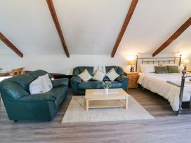 A living room with a sofa and bed at Loft apartment in Llandysul