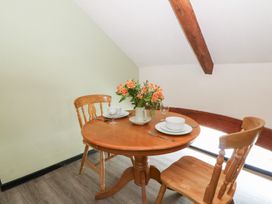 A dining area with a table and chairs at Loft apartment in Llandysul