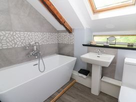 A bathroom with a bathtub and sink at Loft apartment in Llandysul