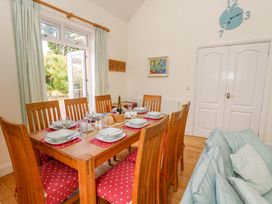 A dining room with a table and chairs at 1 Fernhill Avenue Weymouth