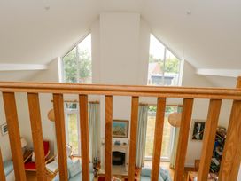 A living room with a balcony view at 1 Fernhill Avenue in Weymouth