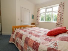 A bedroom with a bed and window at 1 Fernhill Avenue Weymouth