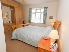 A bedroom with a bed and wardrobe at 1 Fernhill Avenue in Weymouth