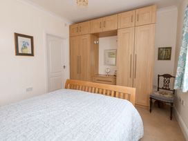 A bedroom with a bed and wardrobe at 1 Fernhill Avenue Weymouth