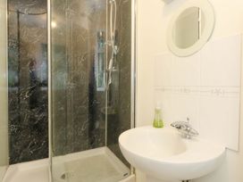 A bathroom with a shower and sink at 1 Fernhill Avenue Weymouth
