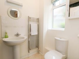A bathroom with a sink and toilet at 1 Fernhill Avenue Weymouth