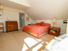 A bedroom with a bed, dresser and chair at 1 Fernhill Avenue Weymouth