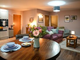 A living room with a table and chairs and a couch at Ystrad Wen near Newbridge-On-Wye