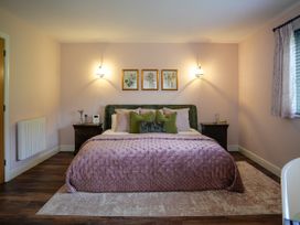 A bedroom with a bed and bedside tables at Ystrad Wen in Llysdinam near Newbridge-On-Wye