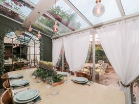 A dining room with a table set for a meal at Yarn Cottage in Broadway