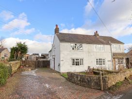 A white semi detached house with multiple windows and a brick driveway at Bwthyn Llwyncaron in Rhydtalog near Llandegla
