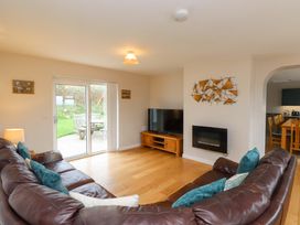 A living room with a sofa and television at Belan Wen Llanddona near Pentraeth