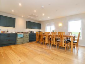 A kitchen with dining table and chairs at Belan Wen Llanddona near Pentraeth