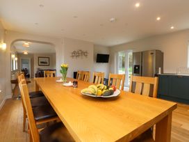A kitchen with a large wooden table and fruit on it at Belan Wen, Llanddona near Pentraeth