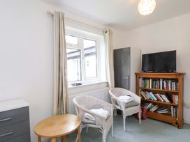 A sitting room with chairs and a television at Belan Wen in Llanddona near Pentraeth