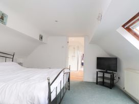 A bedroom with a bed and television at Belan Wen in Llanddona near Pentraeth