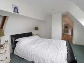 A bedroom with a bed and nightstand at Belan Wen in Llanddona near Pentraeth