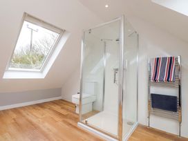A bathroom with a shower and toilet at Belan Wen in Llanddona near Pentraeth