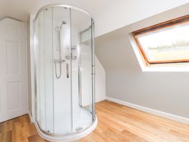 A bathroom with a shower enclosure and window at Belan Wen in Llanddona near Pentraeth