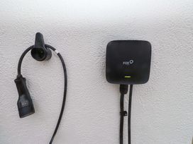 A charging station with cables mounted on a wall at Belan Wen in Llanddona near Pentraeth