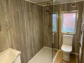 A bathroom with shower, toilet, and sink at Lake View Lodge Lakeside 3, White Cross Bay, Windermere