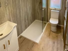 A bathroom with a shower, toilet, and sink at Lake View Lodge, Lakeside 3, White Cross Bay, Windermere