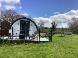 A cabin with deck chairs and a swing at Cherry Pod 2 Hookagate near Meole Brace