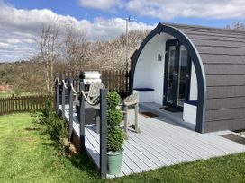 A cabin with a deck and barbecue at Cherry Pod 2 Hookagate near Meole Brace