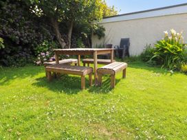 A table and benches in a garden at Porth Ewyn in Trearddur Bay
